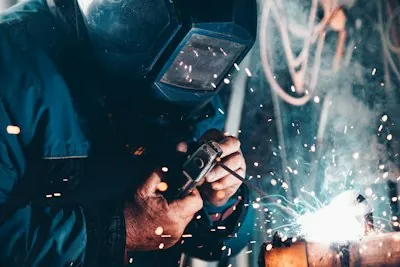 Schweißer bei der Arbeit mit fliegenden Funken